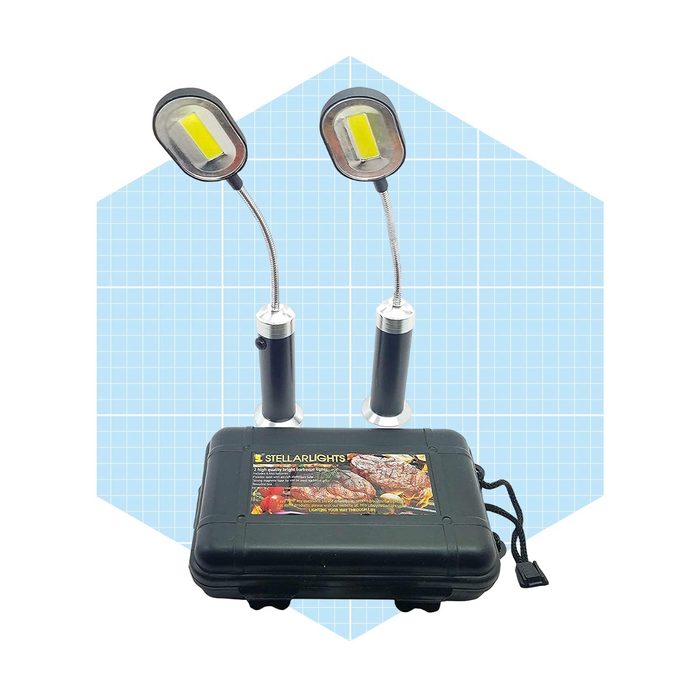 Two flexible arm lights are positioned above a black carrying case. The lights are designed for illuminating various tasks, set against a light blue grid background.