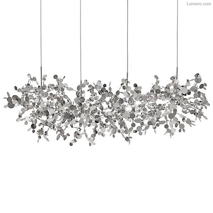 A contemporary chandelier, composed of metallic leaves and circular shapes, hangs from thin cables against a plain white background, creating a modern aesthetic.