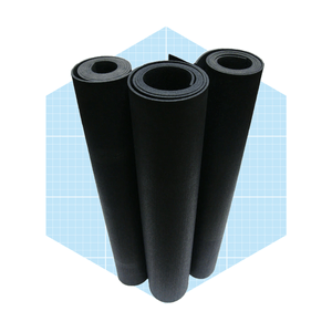 Three rolled black mats stand vertically against a blue grid background, suggesting a storage or display context for flooring or crafting materials.