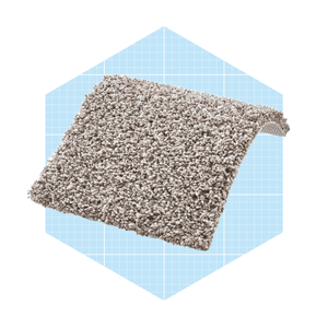 A plush, beige carpet swath lies folded, showcasing its textured surface, set against a soft blue grid-patterned background.