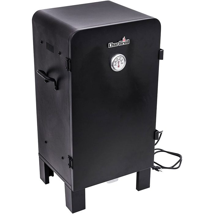 A black electric smoker stands upright with a temperature gauge, designed for cooking food slowly using smoke, typically placed outdoors.