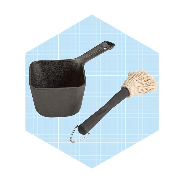 A black metal scoop sits beside a beige mop utensil with a black handle, all displayed on a light blue grid background.