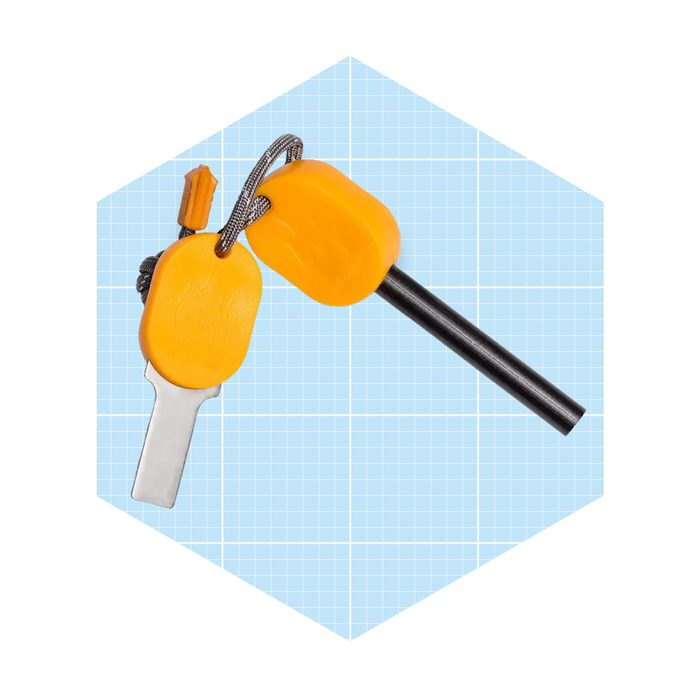 A fire starter tool with a metallic striker and a black rod is displayed against a light blue grid background.