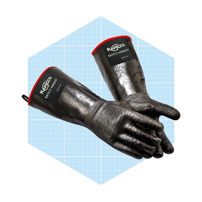 Two black safety gloves with red cuffs are positioned side by side against a light blue grid background. They appear sturdy and suitable for protective use.