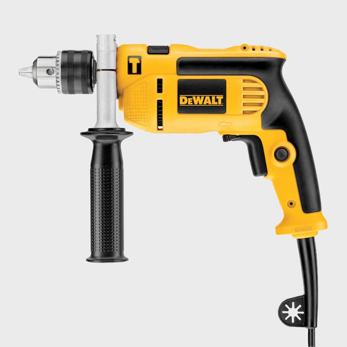 A yellow and black electric drill is positioned horizontally with a chuck at one end, intended for drilling materials in construction or repair tasks.