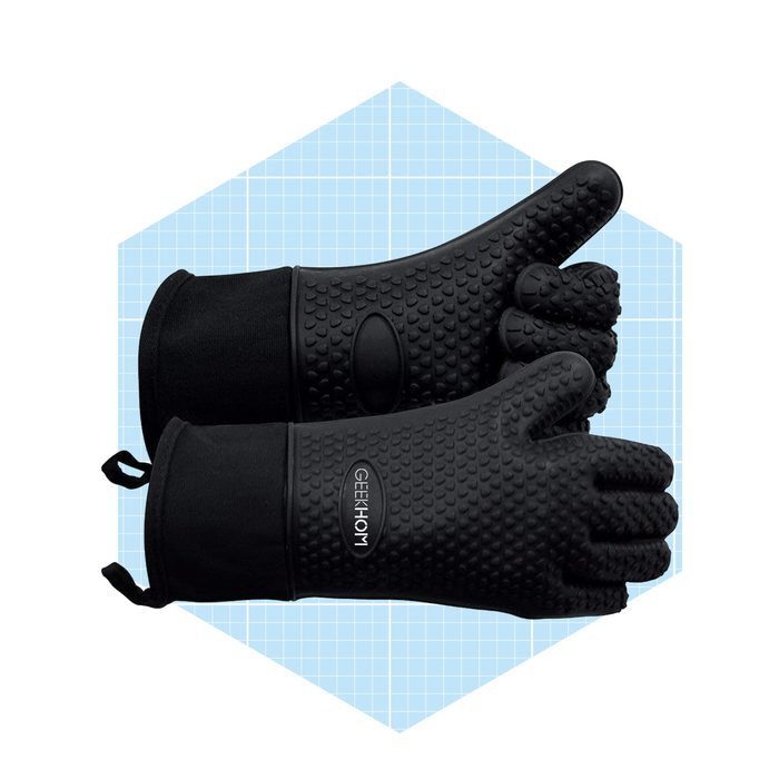 Black heat-resistant silicone gloves are positioned atop one another, showcasing textured surfaces, against a light blue grid background.