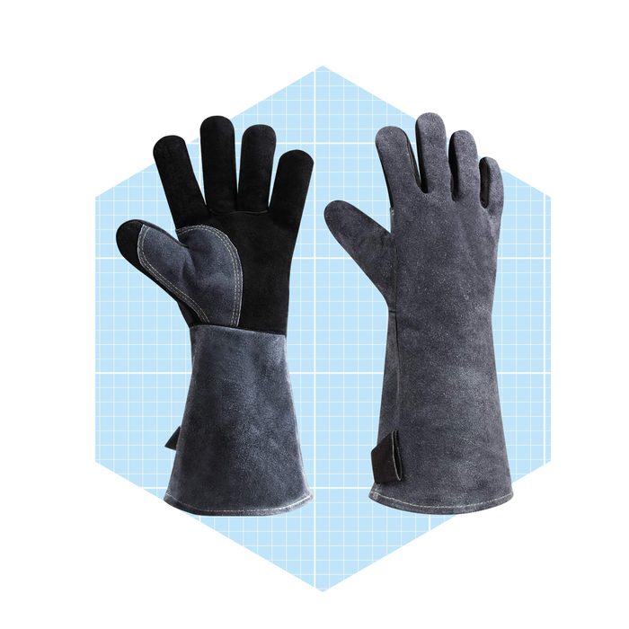 A pair of heat-resistant gloves is displayed side by side. They feature a black suede palm and a darker fabric, set against a blue grid background.