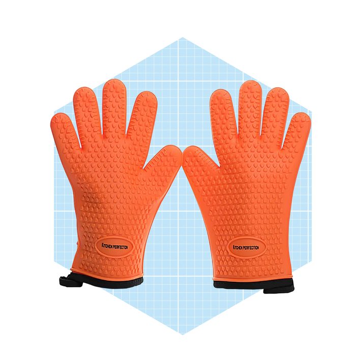 Two orange silicone oven mitts are displayed, with a textured surface for grip, set against a light blue grid background.