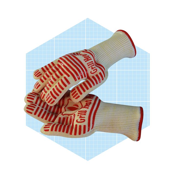 Two pairs of heat-resistant gloves rest together, designed for grilling, featuring a striped pattern and a light background with a grid design.