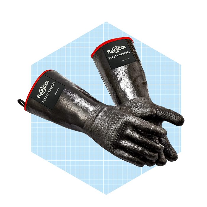 Black safety gloves are positioned together, showcasing their rugged design and red cuffs, set against a light blue grid-patterned background.