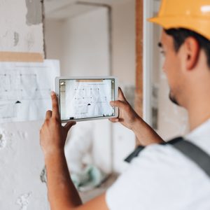 Worker examines project details in apartment